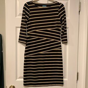 This is a J. McLaughlin tan and black stripe three quarter sleeve dress.